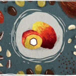 Palm oil fruit surrounded by dates, sunflower seeds, olives, rapeseed, soybeans and coconut